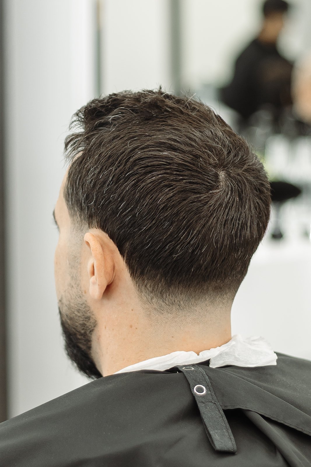 Master Barber consulting with client in leather chair