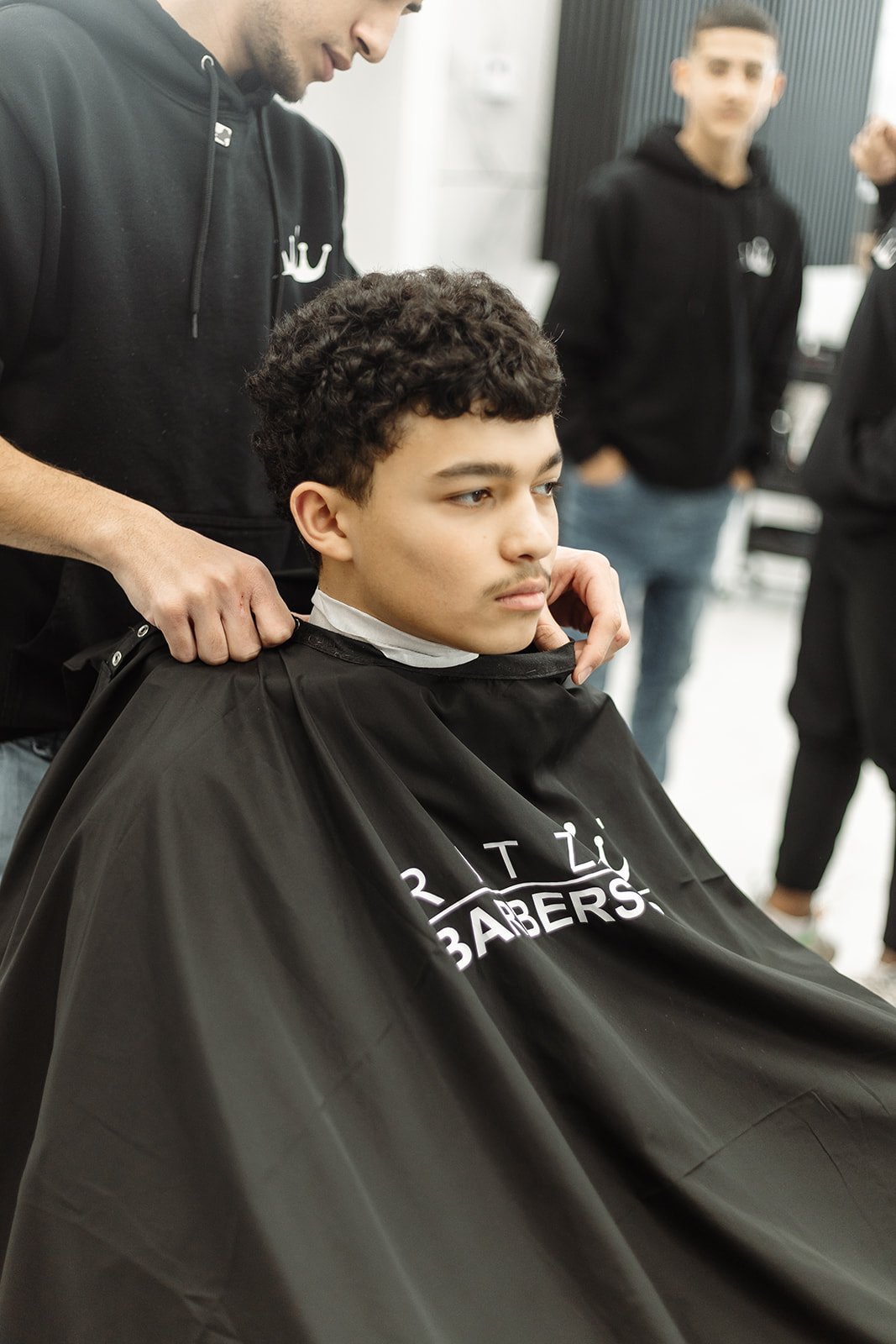 Barber applying styling product with hands