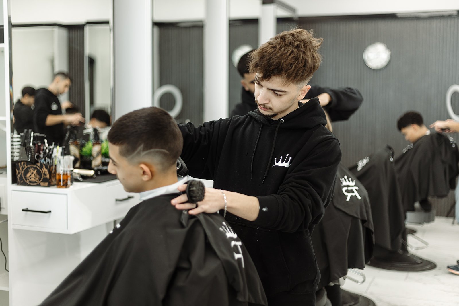 Barber brushing neckline with horsehair neck duster