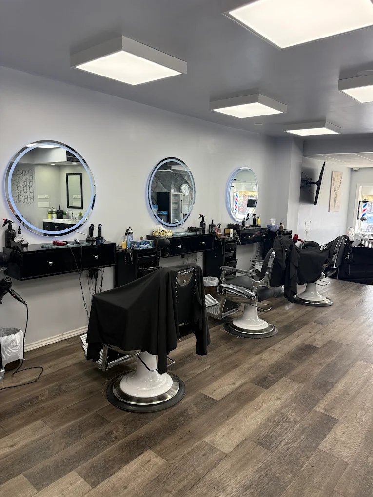 Modern backlit circular LED mirrors and chairs at Ritz Waterdown
